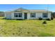 Inviting single-story home with blue shutters, a well-manicured lawn, and an attached garage at 10 Chaney Ln, Louisburg, NC 27549