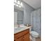 Bathroom boasts a white vanity with wood cabinet and toilet at 100 Hillside Village Dr, Louisburg, NC 27549