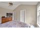 Bright bedroom featuring a vaulted ceiling, neutral walls, dresser and TV at 100 Hillside Village Dr, Louisburg, NC 27549