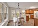 Bright breakfast nook featuring natural light and sleek floors at 100 Hillside Village Dr, Louisburg, NC 27549