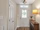Inviting entryway features a decorative glass door, pretty lamp, and beautiful flooring at 100 Hillside Village Dr, Louisburg, NC 27549