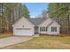 Charming single-Gathering home with attached garage and well-manicured lawn and tall trees at 100 Hillside Village Dr, Louisburg, NC 27549