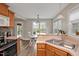 Open kitchen with stainless steel sink, wooden cabinets, and breakfast nook at 100 Hillside Village Dr, Louisburg, NC 27549