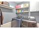 This laundry room features plenty of storage with cabinets and open shelves at 100 Hillside Village Dr, Louisburg, NC 27549