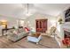 Spacious living room with vaulted ceilings, lots of seating and a cozy fireplace at 100 Hillside Village Dr, Louisburg, NC 27549