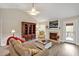 Cozy living room offers a fireplace, built-in shelving, and a door to the deck at 100 Hillside Village Dr, Louisburg, NC 27549