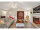 Comfortable living room with nice flooring, fireplace, and ample natural light at 100 Hillside Village Dr, Louisburg, NC 27549