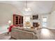 Relaxing living room with vaulted ceiling, a fireplace, and bright natural light at 100 Hillside Village Dr, Louisburg, NC 27549