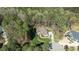 Aerial view of a well-maintained estate home nestled among towering trees at 1009 High Trail Ct, Wake Forest, NC 27587