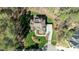 An aerial view showcases the layout of the house with a patio, and driveway surrounded by mature trees at 1009 High Trail Ct, Wake Forest, NC 27587