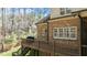 Exterior of a brick home, highlighting a spacious back deck with stairs leading to the yard at 1009 High Trail Ct, Wake Forest, NC 27587