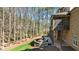 Beautiful backyard featuring a stone fire pit, outdoor seating, and a screened-in porch overlooking a wooded area at 1009 High Trail Ct, Wake Forest, NC 27587