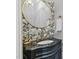 Stylish powder room with patterned wallpaper, a decorative mirror, and a vanity with a sink at 1009 High Trail Ct, Wake Forest, NC 27587