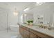 Luxurious bathroom featuring a soaking tub, double vanity, and elegant chandelier at 1009 High Trail Ct, Wake Forest, NC 27587
