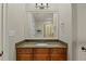 Bathroom featuring granite countertops and a framed mirror over wood cabinets at 1009 High Trail Ct, Wake Forest, NC 27587