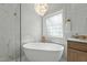 Bright bathroom showcasing a soaking tub, walk-in shower, and marble accents at 1009 High Trail Ct, Wake Forest, NC 27587