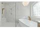 Luxurious bathroom showcasing a soaking tub, walk-in shower, and marble accents at 1009 High Trail Ct, Wake Forest, NC 27587