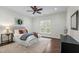 Bright bedroom with wood floors, a ceiling fan, and a large window offering lots of natural light at 1009 High Trail Ct, Wake Forest, NC 27587