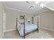 Charming bedroom featuring a four-poster bed with floral bedding and neutral colored walls and carpet at 1009 High Trail Ct, Wake Forest, NC 27587