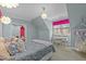 Bright bedroom with natural light, a cozy hammock chair, and stylish decor at 1009 High Trail Ct, Wake Forest, NC 27587
