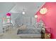 Bright bedroom with pink accent wall, gray bedding, hammock chair, and a desk with chair at 1009 High Trail Ct, Wake Forest, NC 27587