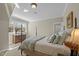 Well lit bedroom featuring a four poster bed, ample natural light, and a neutral color scheme at 1009 High Trail Ct, Wake Forest, NC 27587
