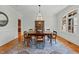 Traditional dining room with hardwood floors, decorative rug, elegant chandelier and a window at 1009 High Trail Ct, Wake Forest, NC 27587
