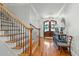 Inviting foyer with hardwood floors, staircase, decorative console table and a stylish chandelier at 1009 High Trail Ct, Wake Forest, NC 27587