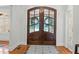 Stunning entryway featuring a decorative double-door entrance, hardwood flooring, and a stylish rug at 1009 High Trail Ct, Wake Forest, NC 27587