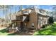 A view of the home's exterior, showcasing the brick facade, screened porch, firepit, and well-maintained landscaping at 1009 High Trail Ct, Wake Forest, NC 27587