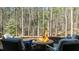 Inviting fire pit with comfortable seating, set against a backdrop of serene woods at 1009 High Trail Ct, Wake Forest, NC 27587
