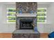 Detailed stone fireplace with built-in shelving, providing a focal point for the room at 1009 High Trail Ct, Wake Forest, NC 27587