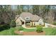 Charming front exterior with a stone facade, mature landscaping, and a welcoming entryway at 1009 High Trail Ct, Wake Forest, NC 27587