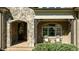 Inviting front porch featuring brick flooring, chairs, decorative door with stone surround and window at 1009 High Trail Ct, Wake Forest, NC 27587