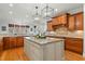 Bright and spacious kitchen with hardwood floors, kitchen island, and stainless steel appliances at 1009 High Trail Ct, Wake Forest, NC 27587