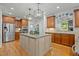 Large kitchen island with granite countertop, custom cabinets and stainless steel appliances at 1009 High Trail Ct, Wake Forest, NC 27587