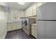 Convenient laundry room with washer, dryer, sink, storage cabinets and refrigerator at 1009 High Trail Ct, Wake Forest, NC 27587