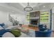 Bright living room featuring stone fireplace, modern lighting, hardwood floors, and a comfortable seating area at 1009 High Trail Ct, Wake Forest, NC 27587