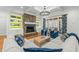 Cozy living room with a stone fireplace, coffered ceiling, built-in shelves, and access to the porch at 1009 High Trail Ct, Wake Forest, NC 27587