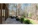 A beautifully landscaped patio with comfortable seating, ideal for enjoying the tranquil wooded surroundings at 1009 High Trail Ct, Wake Forest, NC 27587