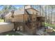Beautiful home showcasing a two-story deck, brick facade, and a stone patio with an outdoor firepit at 1009 High Trail Ct, Wake Forest, NC 27587