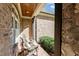 Comfortable side porch area featuring brick flooring, comfortable chairs with cushions, wood columns and exterior decor at 1009 High Trail Ct, Wake Forest, NC 27587