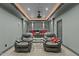 Enjoy movies in this theater room, featuring two gray recliners and a projector at 1009 High Trail Ct, Wake Forest, NC 27587