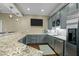 Stylish basement wet bar with granite countertops and stainless steel appliances at 1009 High Trail Ct, Wake Forest, NC 27587