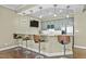Basement wet bar with modern cabinets, granite counters, and bar seating at 1009 High Trail Ct, Wake Forest, NC 27587
