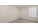 A bedroom with neutral paint color, carpet and a window at 1100 Ursa Major Ct, Wendell, NC 27591