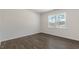 Spacious bedroom showcasing a large window and luxury vinyl plank flooring at 1100 Ursa Major Ct, Wendell, NC 27591