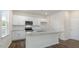 A kitchen featuring white cabinets, granite countertops, stainless steel appliances, and luxury vinyl plank floors at 1100 Ursa Major Ct, Wendell, NC 27591