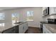 A kitchen featuring white cabinets, granite countertops, stainless steel appliances, and luxury vinyl plank floors at 1100 Ursa Major Ct, Wendell, NC 27591