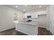 A kitchen featuring white cabinets, granite countertops, stainless steel appliances, and luxury vinyl plank floors at 1100 Ursa Major Ct, Wendell, NC 27591